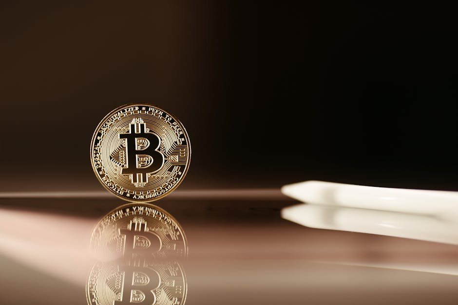 A close-up image of a Bitcoin coin reflecting on a shiny surface, highlighting cryptocurrency themes.